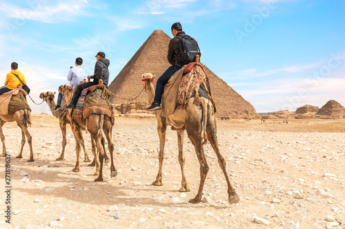 Tourists on camels near the Pyramids of Giza  Egypt