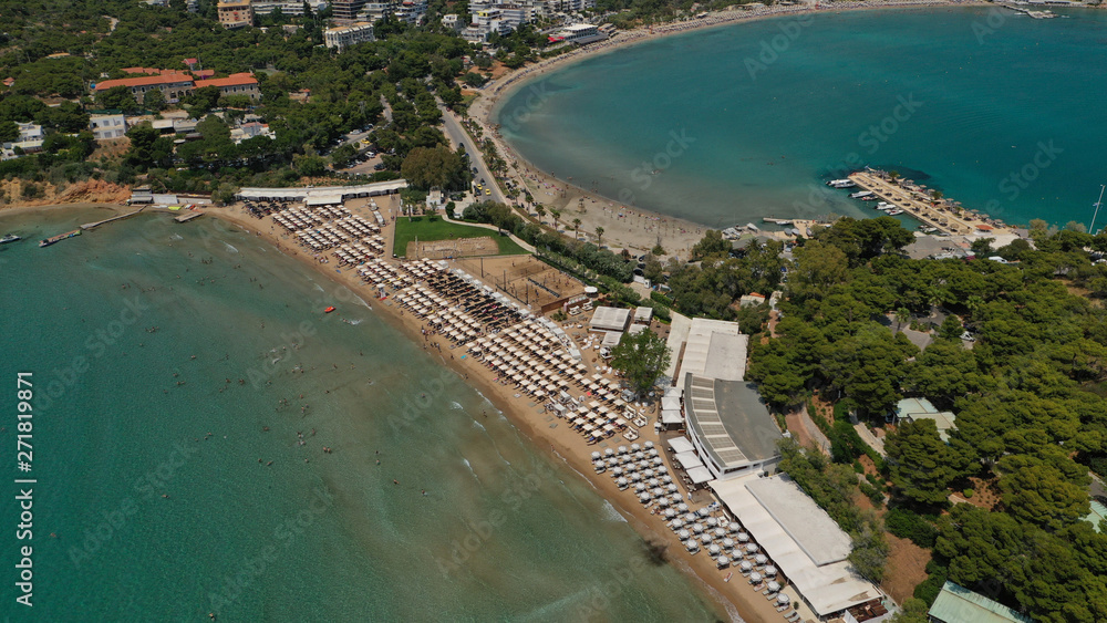 Aerial drone bird's eye panoramic photo of famous celebrity sandy beach of Astir or Asteras in south Athens riviera with turquoise clear waters, Vouliagmeni, Greece Aerial drone bird's eye panoramic photo of famous celebrity sandy beach of Astir or Asteras in south Athens riviera with turquoise clear waters, Vouliagmeni, Greece