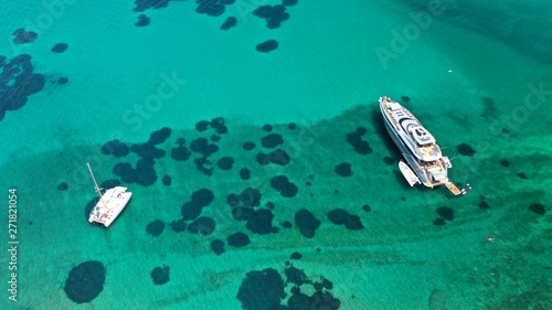Aerial drone top view photo of sail boat docked in tropical exotic bay with emerald calm sea