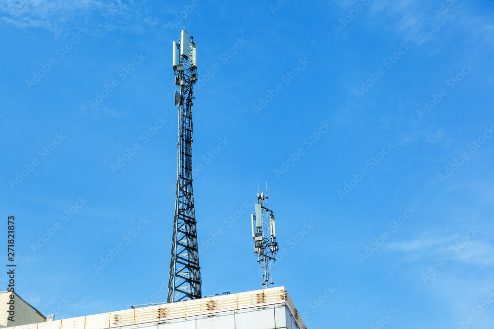 The cell tower with 3G, 4G and 5G communications. Base station for operating mobile phones, receiving and sending a signal. Antenna for wireless communication. Cellular systems in the city. The cell tower with 3G, 4G and 5G communications. Base station for operating mobile phones, receiving and sending a signal. Antenna for wireless communication. Cellular systems in the city.
