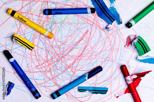 A Child's Crayon Drawing/scribbles with Generic Crayons and torn lable pieces from stripping the label.  The center of the image is open for Copy Writing. photo