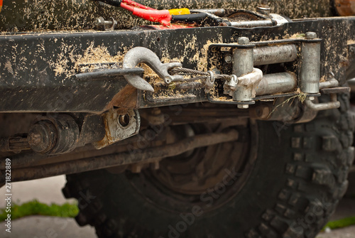 Dirty parts of a truck close up. Elements of the engine and suspension. Winch and rope on an SUV.