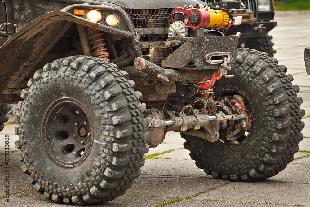 Dirty parts of a truck close up. Elements of the engine and suspension. Winch and rope on an SUV. Dirty parts of a truck close up. Elements of the engine and suspension. Winch and rope on an SUV.