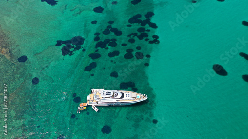 Aerial drone bird's eye view of small islet of Ydrousa with turquoise and sapphire clear waters and only one mile distance from coast in Voula, Athens riviera, Attica, Greece © aerial-drone