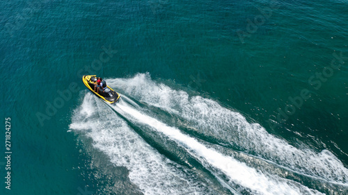 Wallpaper Mural Aerial drone top view photo of jet ski cruising in high speed in emerald exotic tropical bay Torontodigital.ca