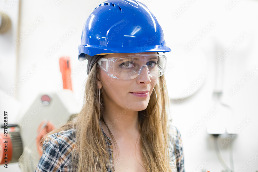 young woman worker with protective helmet young woman worker with protective helmet