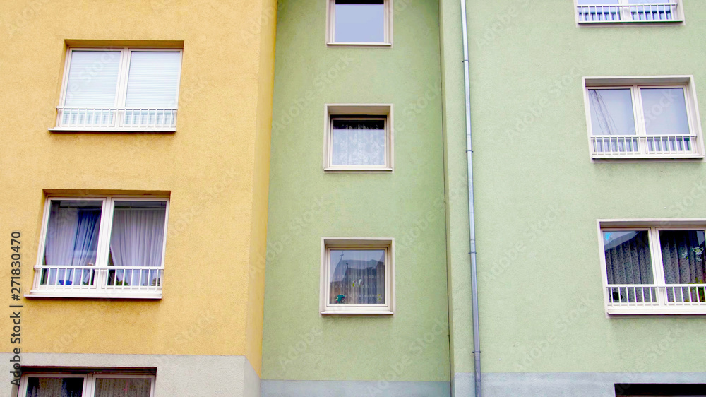 yellow and green color colorful building facade with windows. modern german european architecture style.