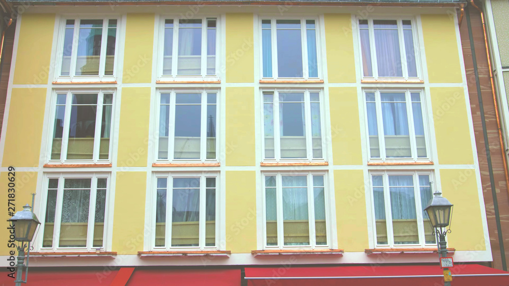 yellow colorful building facade with windows. modern german european architecture style.