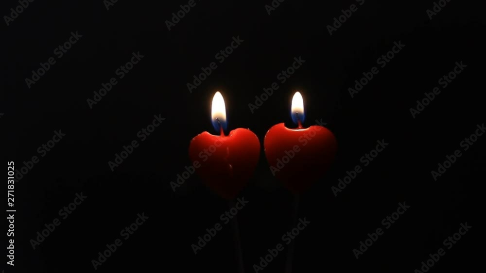 Couple of two red candles lightning in black dark, romantic eternal love, conceptual Couple of two red candles lightning in black dark, romantic eternal love, conceptual