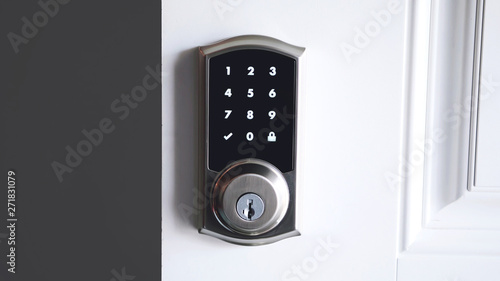 Digital smart door lock security system with the password, close up on numbers on the screen.