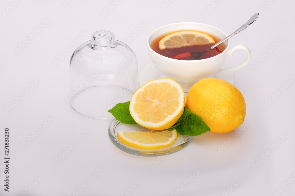 Fresh lemons, a cup of tea on a white background. Fresh lemons, a cup of tea on a white background.