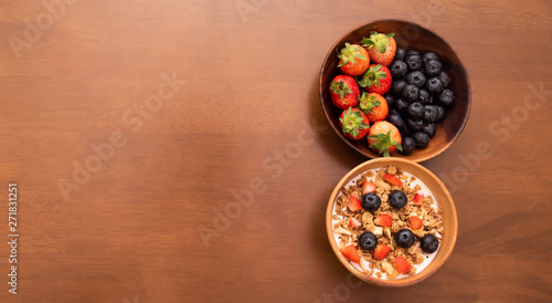 fresh cereal and milk with strawberry and blueberry in bowl, Copy space on the left