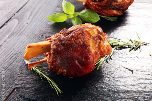 Canvas Print Smoked ham hock with herbs and spices on stone plate.