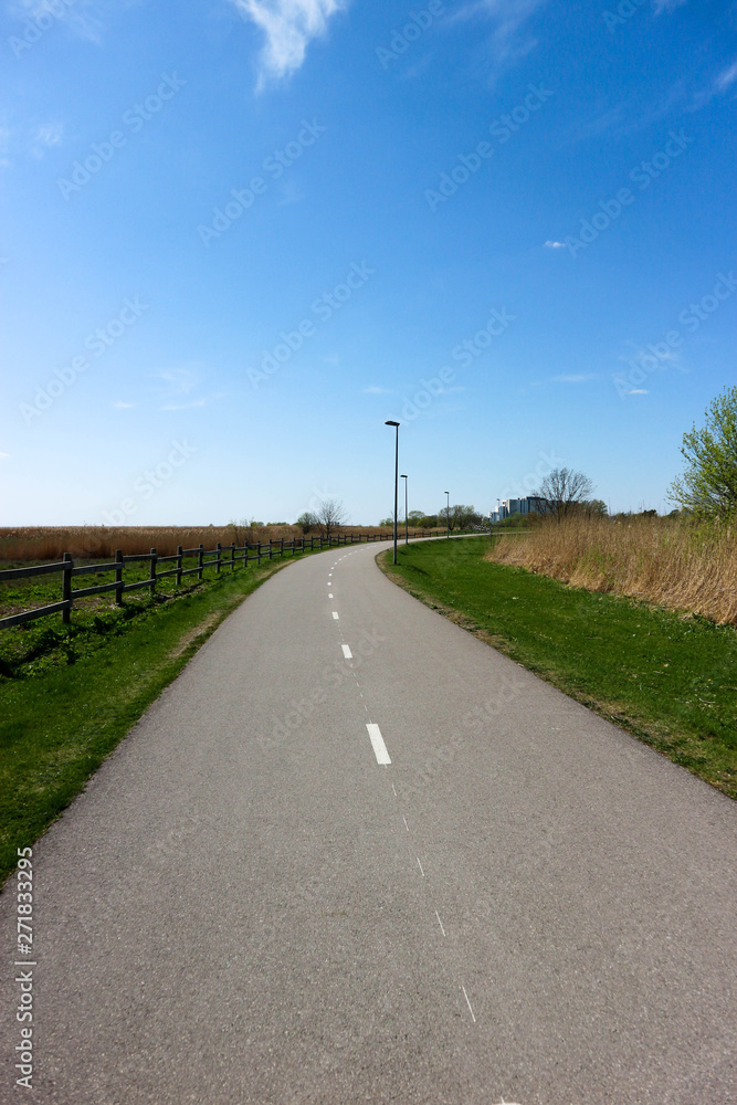 Picturesque bicycle road on the Baltic sea shore under blue sky, Parnu, Estonia Picturesque bicycle road on the Baltic sea shore under blue sky, Parnu, Estonia
