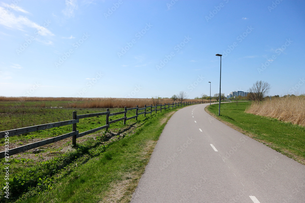 Picturesque bicycle road on the Baltic sea shore under blue sky, Parnu, Estonia Picturesque bicycle road on the Baltic sea shore under blue sky, Parnu, Estonia