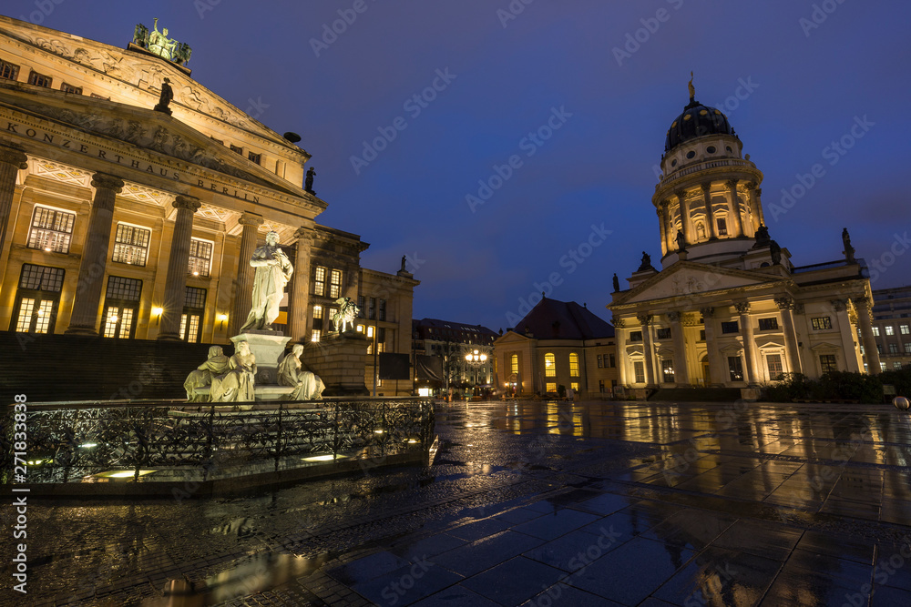 Illuminated Schiller Monument, facade of the Konzerthaus Berlin (Berlin Concert Hall) and Französischer Dom (French Cathedral) at the Gendarmenmarkt Square in Berlin, Germany, in the evening.