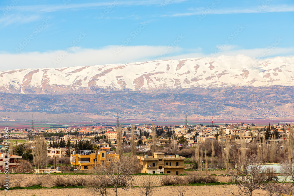 Lebanese houses in Beqaa Valley with snow cap mountains in the background, Baalbeck, Lebanon