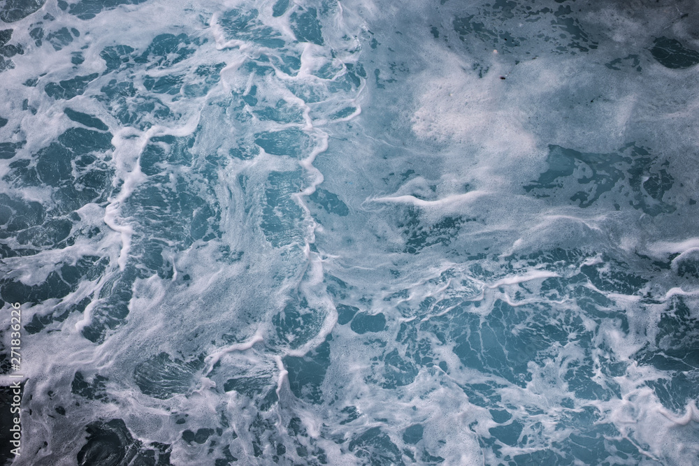 blue ocean waves creating white foam seen from above. blue ocean waves creating white foam seen from above.
