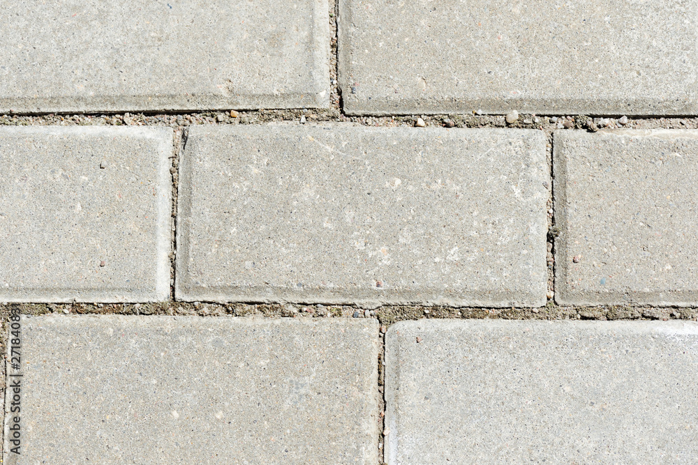 Fototapeta premium Gray paving slabs texture close up. Paving slabs background