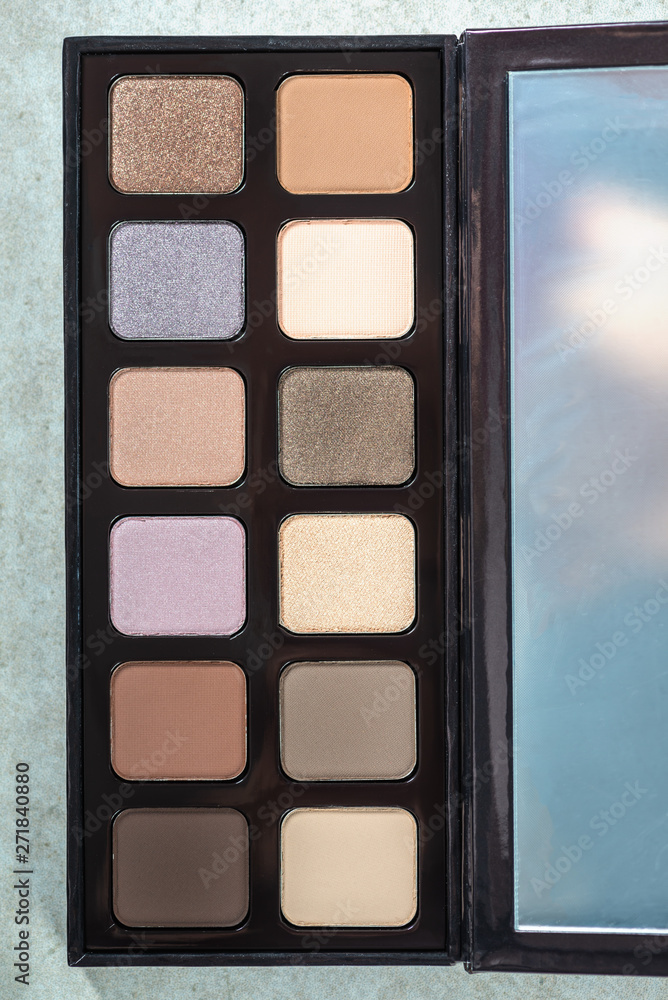 Fototapeta premium Neutral color eye shadows palette on grey background