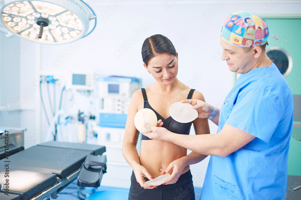 The girl, who wants to correct sagging breasts, at the receptio The girl, who wants to correct sagging breasts, at the receptio
