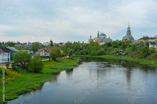 Panorama of Torzhok with views of the river and dwelling houses and a church standing in the distance