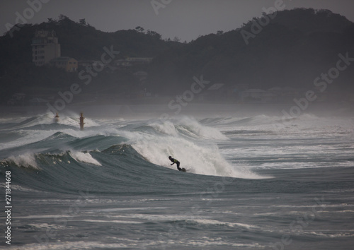 Japanese surfer in the contaminated area after the daiichi nuclear power plant irradiation, Fukushima prefecture, Tairatoyoma beach, Japan photo