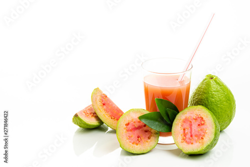 Guava juice and peeled fruit on white background.