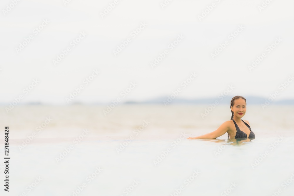Portrait beautiful young asian woman wear bikini around swimming pool in hotel resort nearly sea ocean beach Portrait beautiful young asian woman wear bikini around swimming pool in hotel resort nearly sea ocean beach