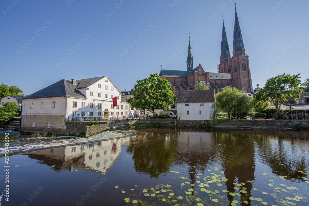 Beautiful view of beutiful white houses and cathedral church reflecting on the water surface. Gorgeous nature landscape backgrounds.