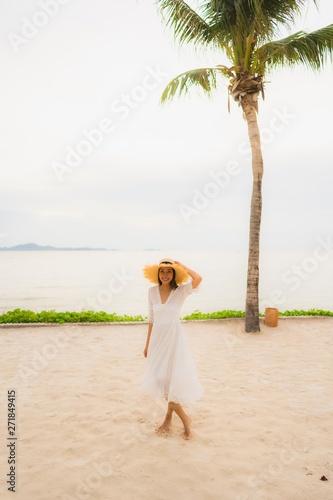 Portrait beautiful asian woman wear hat with smile happy leisure on the beach and sea in holiday vacation