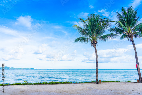 Beautiful landscape of beach sea ocean with coconut palm tree with white cloud and blue sky