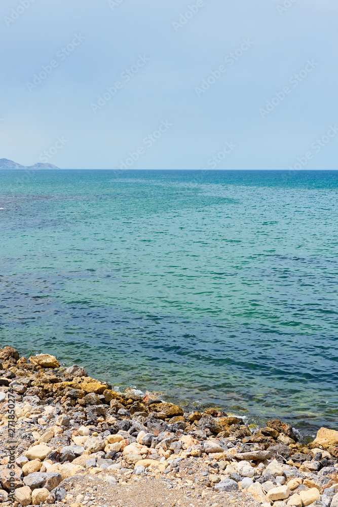                         Stone beach of mediterranean sea in daytime. Natural background.     