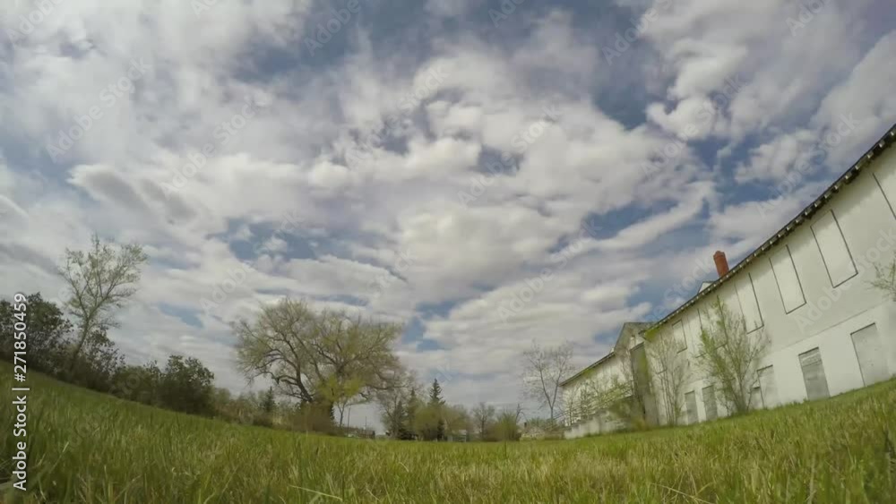 TIME LAPSE - Old abandoned hospital in a small town on a cloudy nice sunny day. ( 4k footage ) TIME LAPSE - Old abandoned hospital in a small town on a cloudy nice sunny day. ( 4k footage )