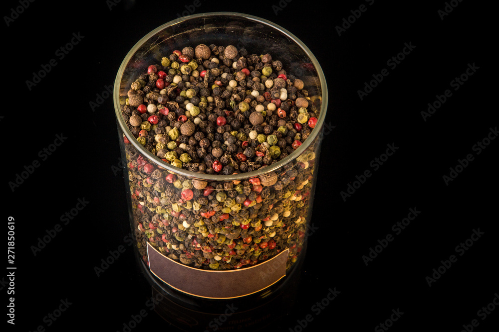 top view of mix assorted peppercorns in deep glass jar