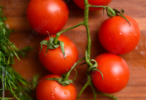 Macro picture of heap of cherry tomatos on wooden surface