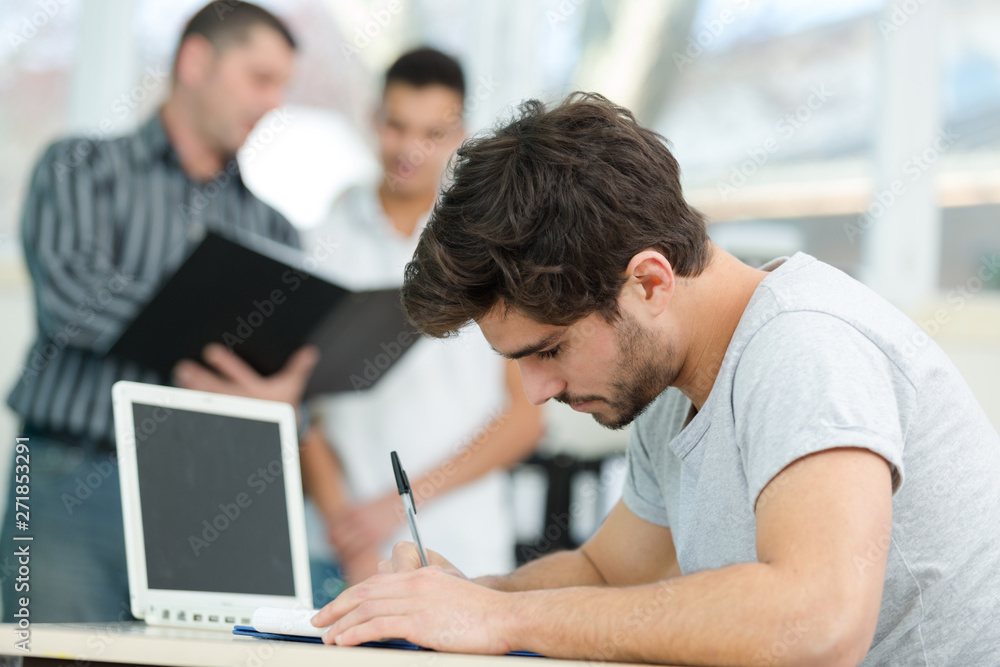 young man taking notes student young man taking notes student