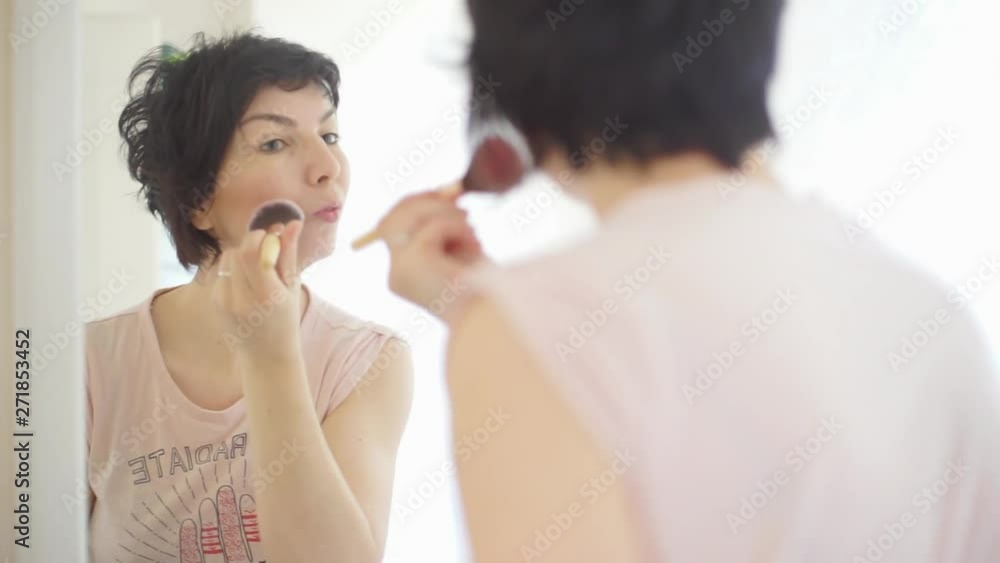 girl does a make-up brush, close-up