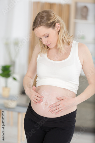 Free Download pregnant woman applying cream to belly - GFXLoad