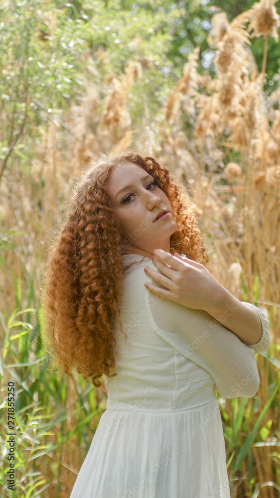redheaded boho style female model in golden field redheaded boho style female model in golden field
