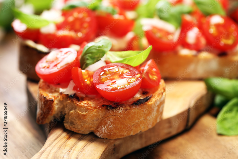 Traditional italian antipasto bruschetta appetizer with cherry tomatoes, cream cheese, basil leaves and balsamic vinegar on cutting board. Antipasti Traditional italian antipasto bruschetta appetizer with cherry tomatoes, cream cheese, basil leaves and balsamic vinegar on cutting board. Antipasti