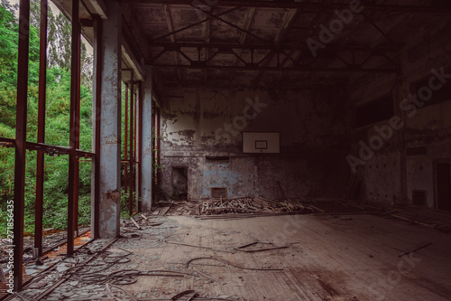Chernobyl Exclusion Zone, Ukraine. School gym in destroyed abandoned ghost city Pripyat ruins after disaster. Fallout lost town, apocalyptic building.