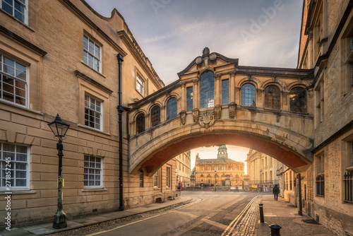 Bridge of sign with the Sheldonian theatre background and street lamp foreground during sunset at Oxford, UK photo