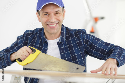 man repairman with hand saw photo