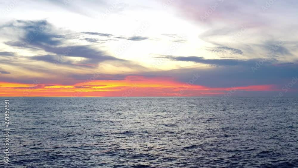 Amazing sunset, sea, the sun with clouds and sun reflection. Open ocean view from boat Amazing sunset, sea, the sun with clouds and sun reflection. Open ocean view from boat