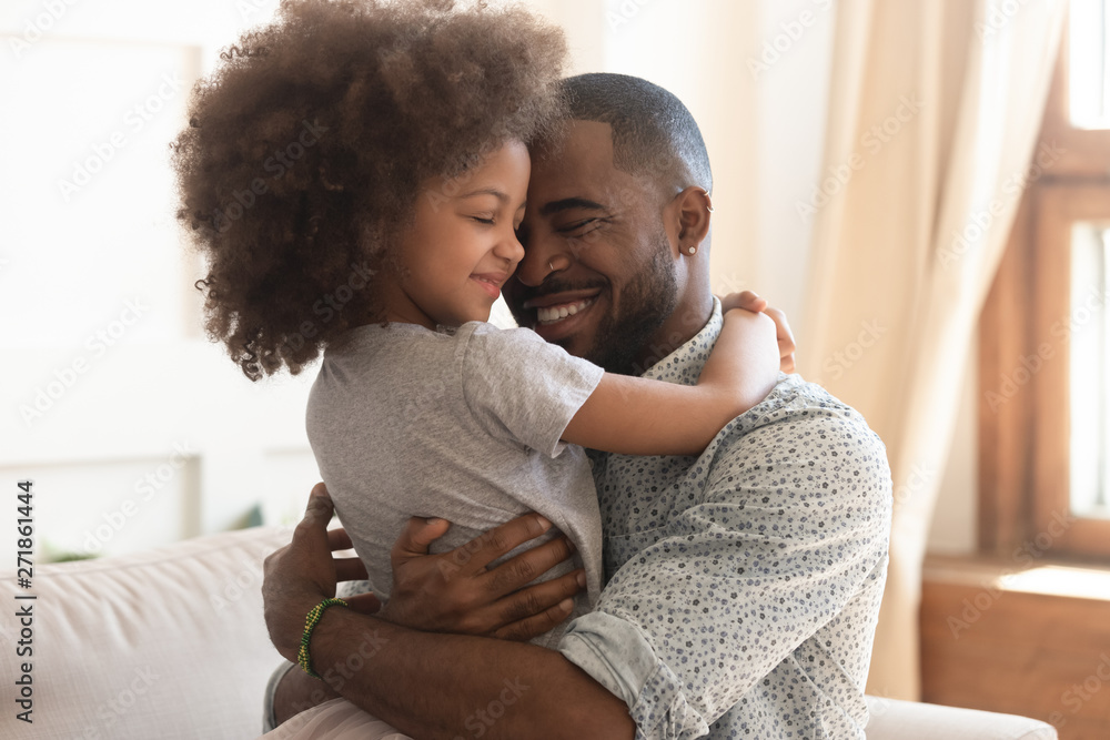 Happy african father holding embracing cute little child daughter - obrazy, fototapety, plakaty 