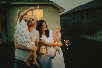 Happy Family doing sparkler fireworks together