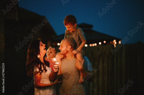 Happy Family doing sparkler fireworks together photo