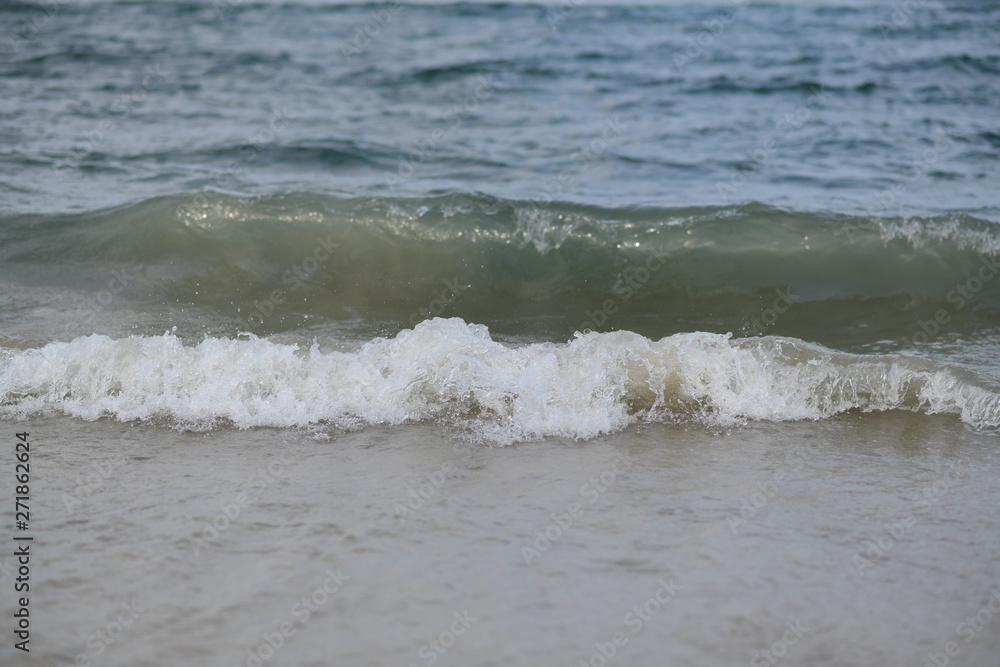 closeup on waves hitting the beach on a sunny summer day closeup on waves hitting the beach on a sunny summer day