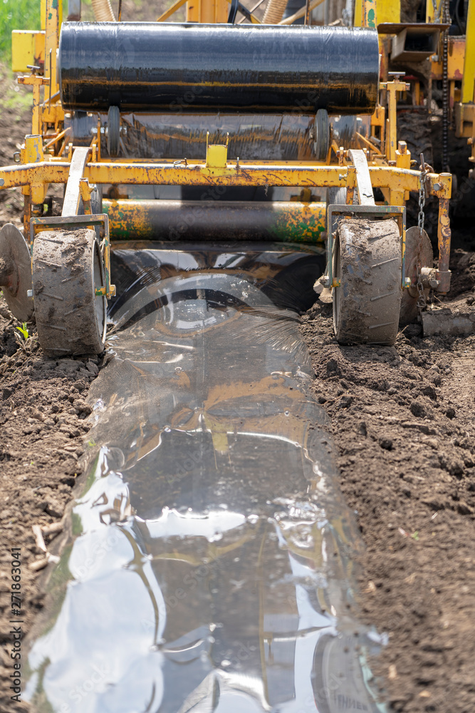 Fototapeta premium Tractor Attachment for Plastic Mulch Bed Laying